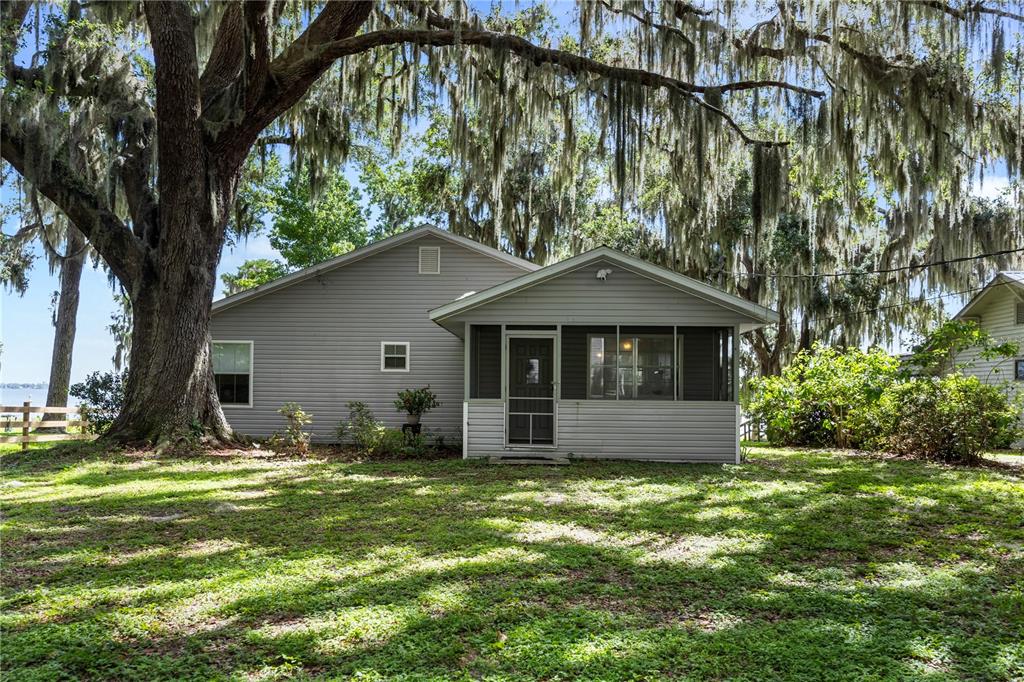 a front view of house with yard and trees