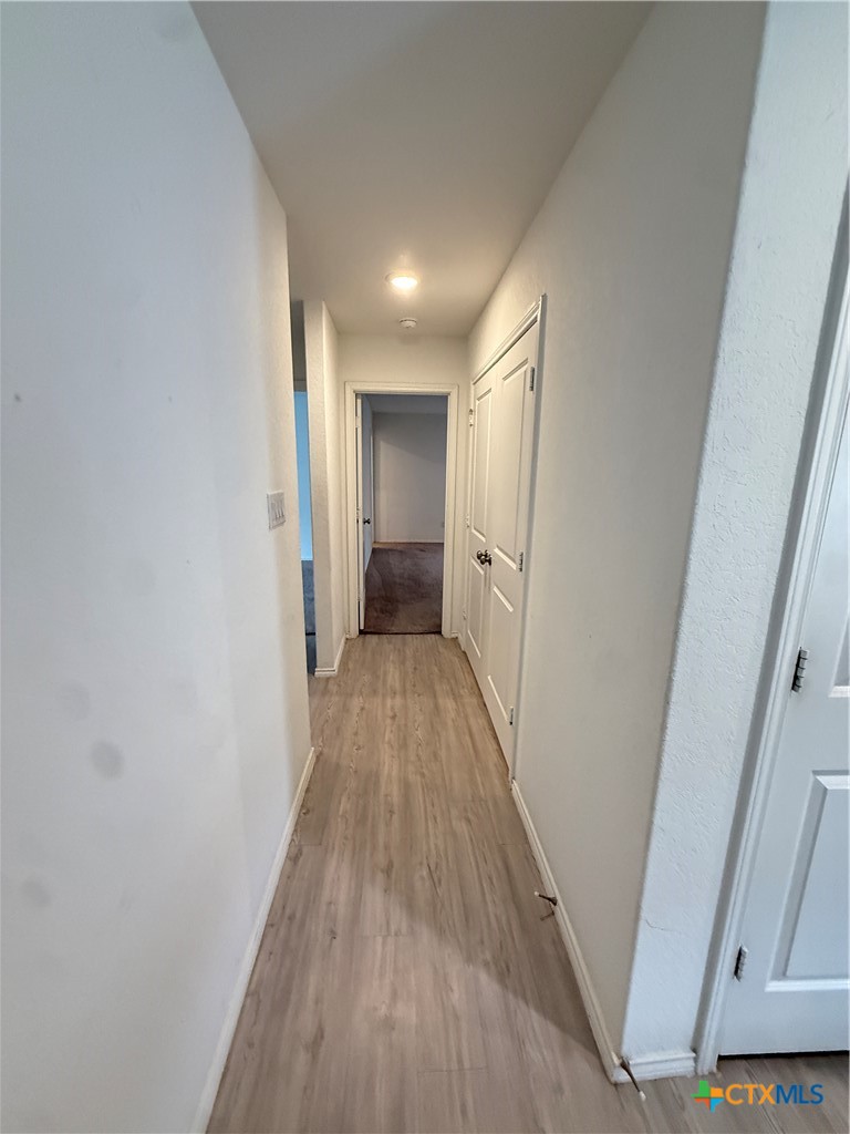 5863 Coahulia Ridge Seguin, TX 78155 - Photo 6 of 15 a view of a hallway with wooden floor
