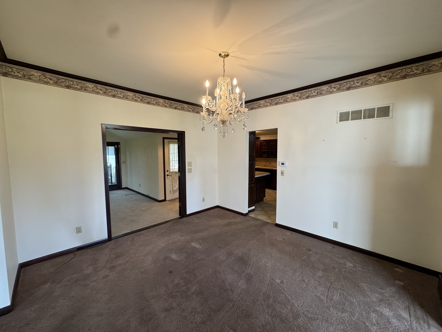 4340 230th Street Walcott, IA 52773 - Photo 15 of 67 a view of an empty room with chandelier and a window