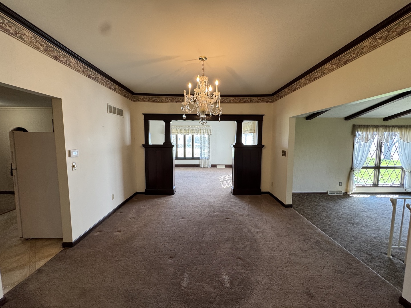 4340 230th Street Walcott, IA 52773 - Photo 17 of 67 an empty room with chandelier and windows