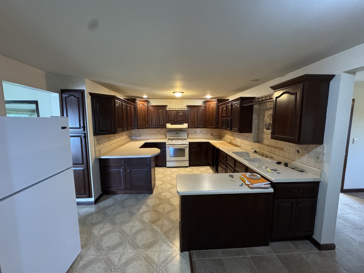 4340 230th Street Walcott, IA 52773 - Photo 19 of 67 a kitchen with stainless steel appliances kitchen island granite countertop a refrigerator and a sink