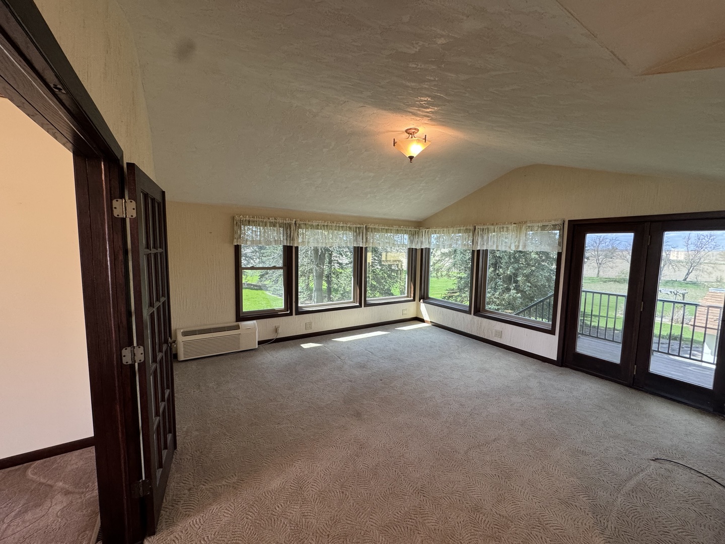 4340 230th Street Walcott, IA 52773 - Photo 23 of 67 a view of a big room with windows and chandelier fan