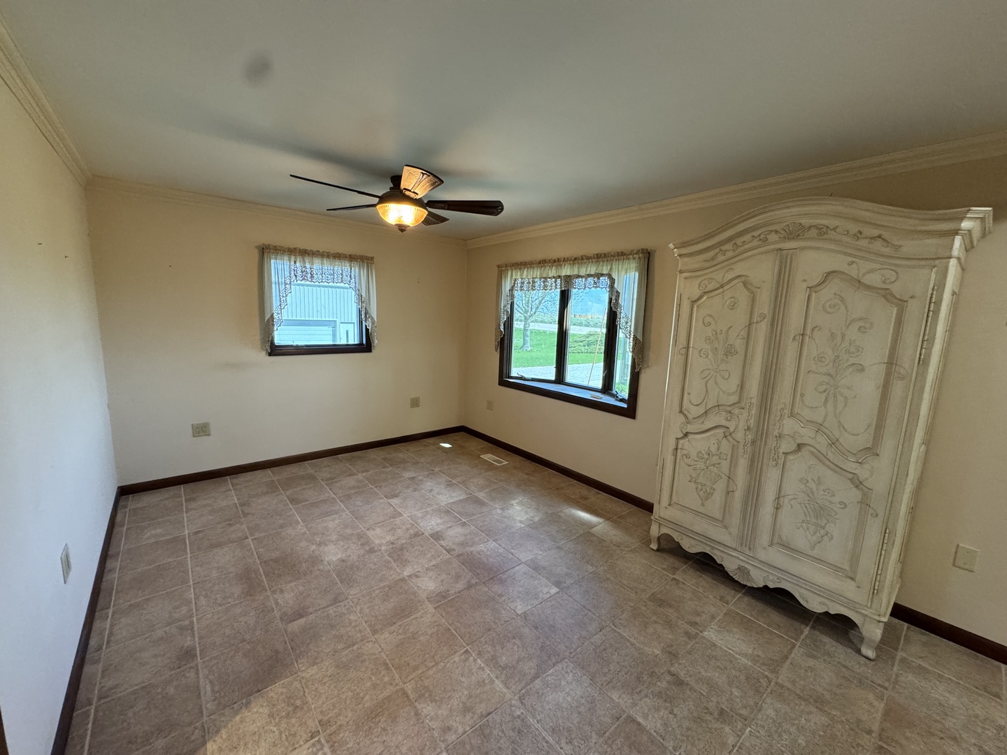 4340 230th Street Walcott, IA 52773 - Photo 27 of 67 an empty room with windows and ceiling fan