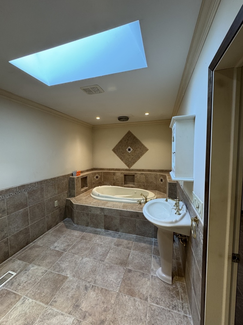 4340 230th Street Walcott, IA 52773 - Photo 29 of 67 a bathroom with a sink and a mirror