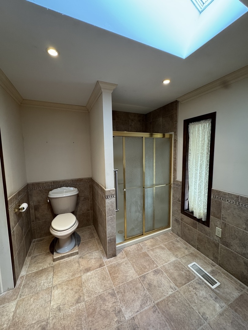 4340 230th Street Walcott, IA 52773 - Photo 31 of 67 a bathroom with a toilet and a shower