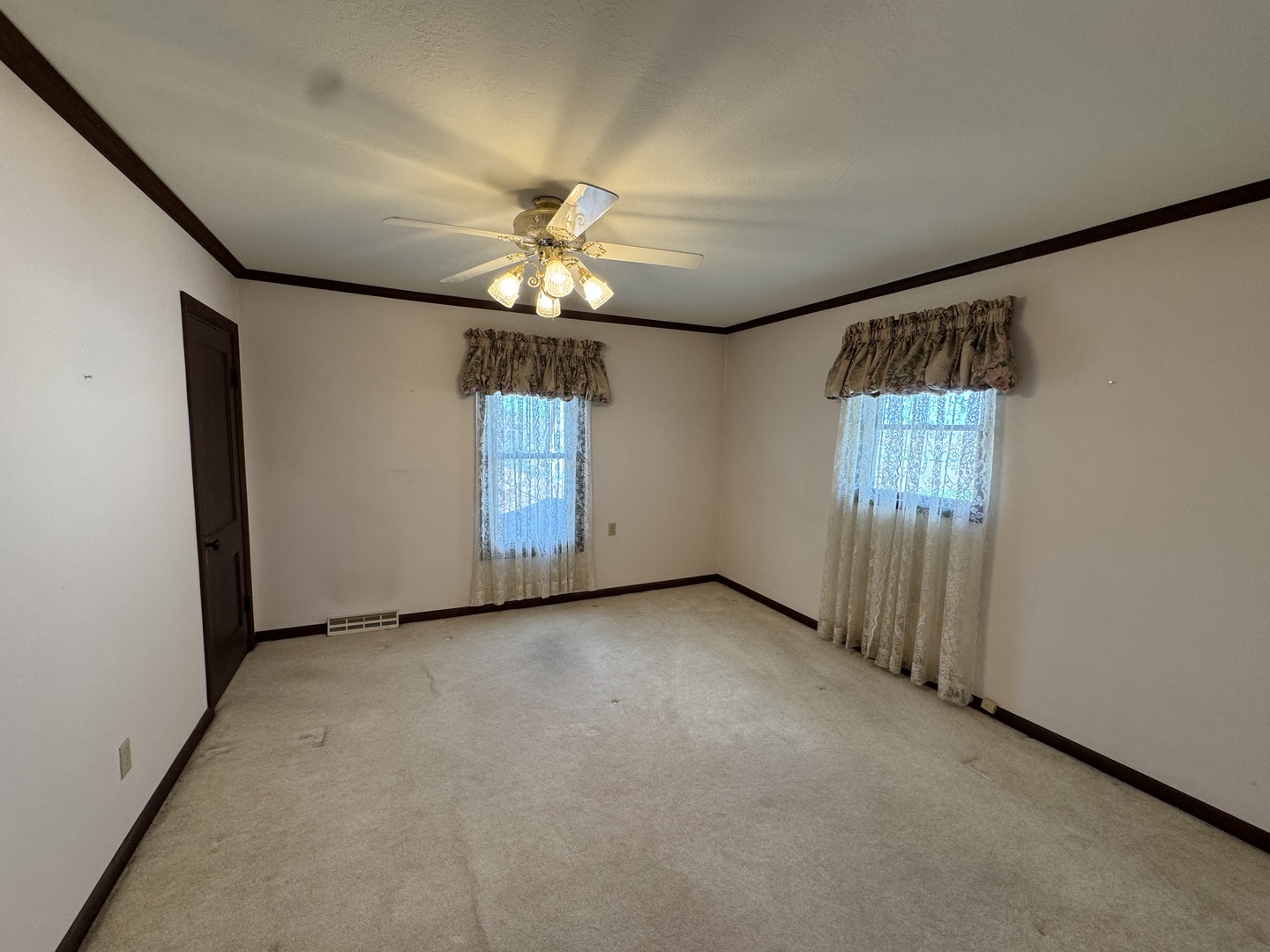 4340 230th Street Walcott, IA 52773 - Photo 32 of 67 an empty room with chandelier fan and windows