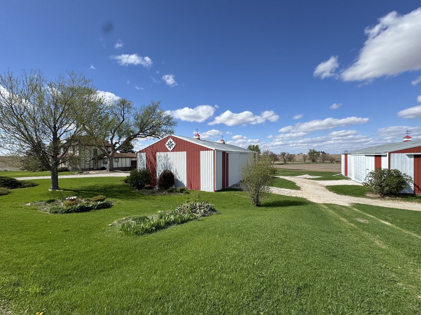 4340 230th Street Walcott, IA 52773 - Photo 61 of 67 a view of a house with a big yard and large trees