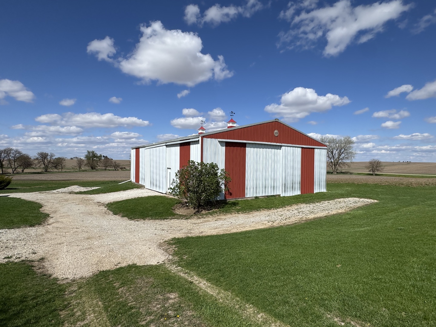 4340 230th Street Walcott, IA 52773 - Photo 62 of 67 a front view of a house with a garden and yard