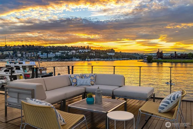 a roof deck with couches and city view