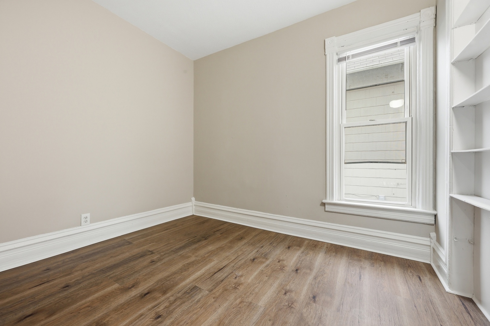 835 Oak Street Elgin, IL 60123 - Photo 11 of 41 a view of a small space with wooden floor and a window