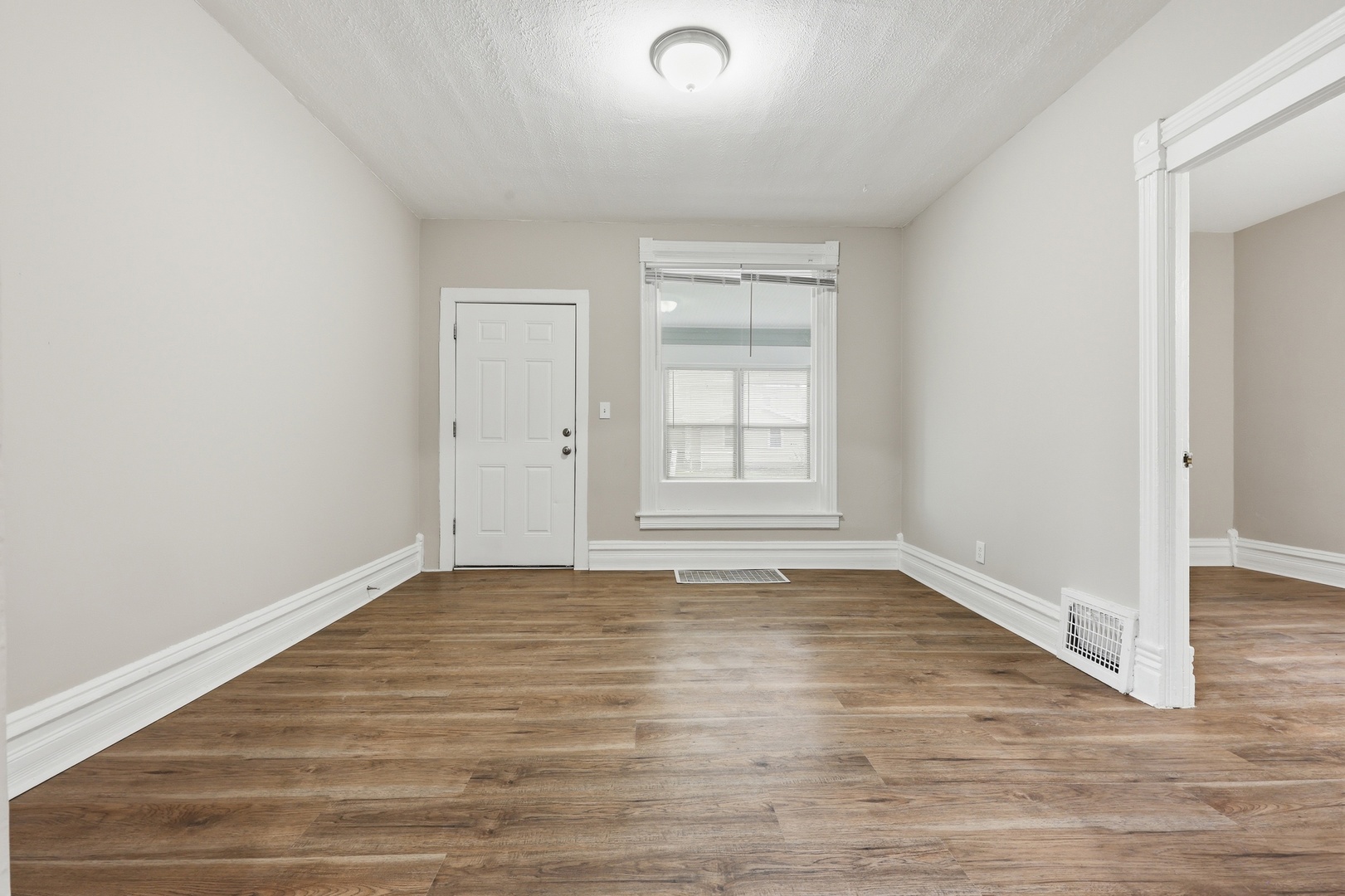 835 Oak Street Elgin, IL 60123 - Photo 12 of 41 a view of an empty room with wooden floor and window