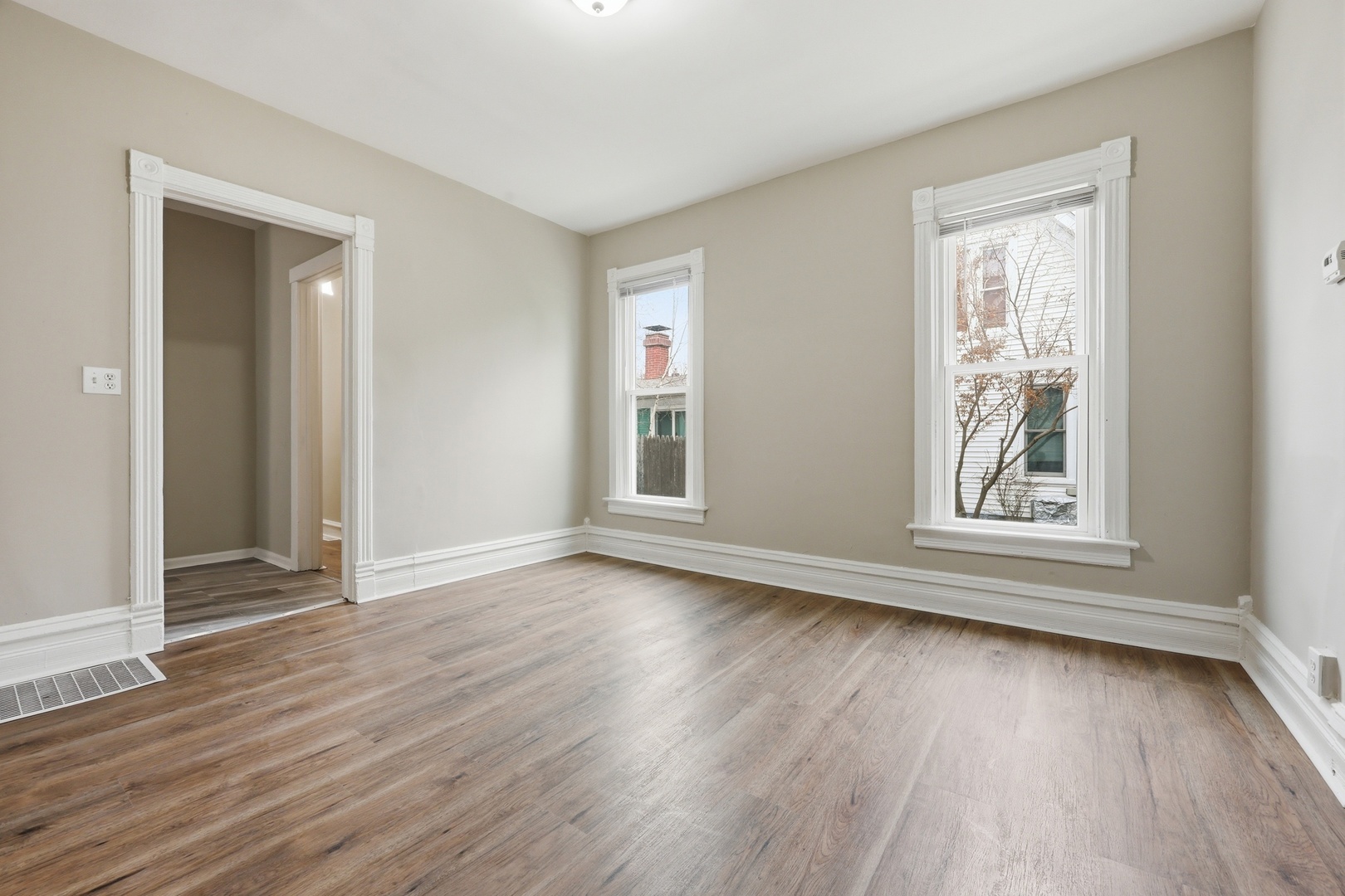 835 Oak Street Elgin, IL 60123 - Photo 13 of 41 a view of an empty room with wooden floor and a window