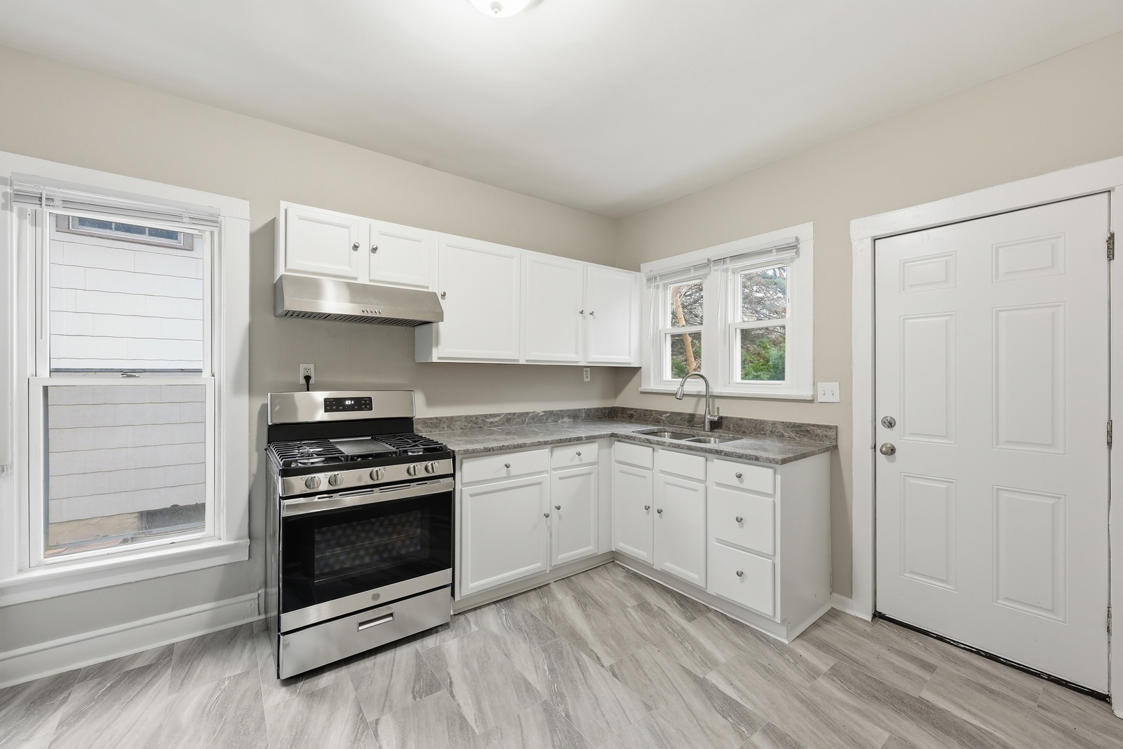 835 Oak Street Elgin, IL 60123 - Photo 14 of 41 a kitchen with stainless steel appliances a stove and white cabinets