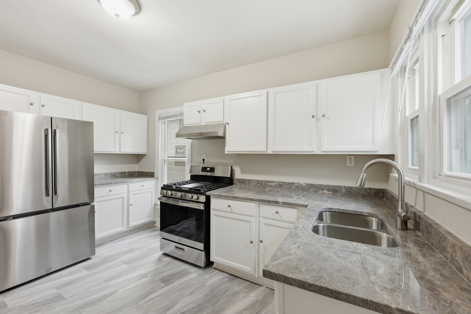 835 Oak Street Elgin, IL 60123 - Photo 15 of 41 a kitchen with a sink wooden floor and stainless steel appliances