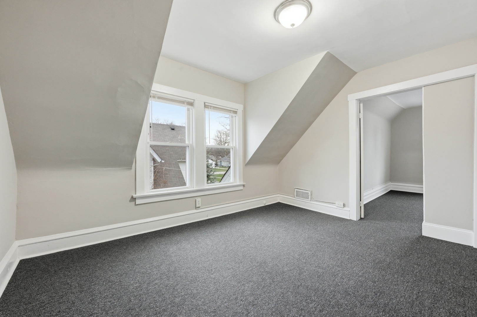 835 Oak Street Elgin, IL 60123 - Photo 27 of 41 an empty room with a fireplace and windows