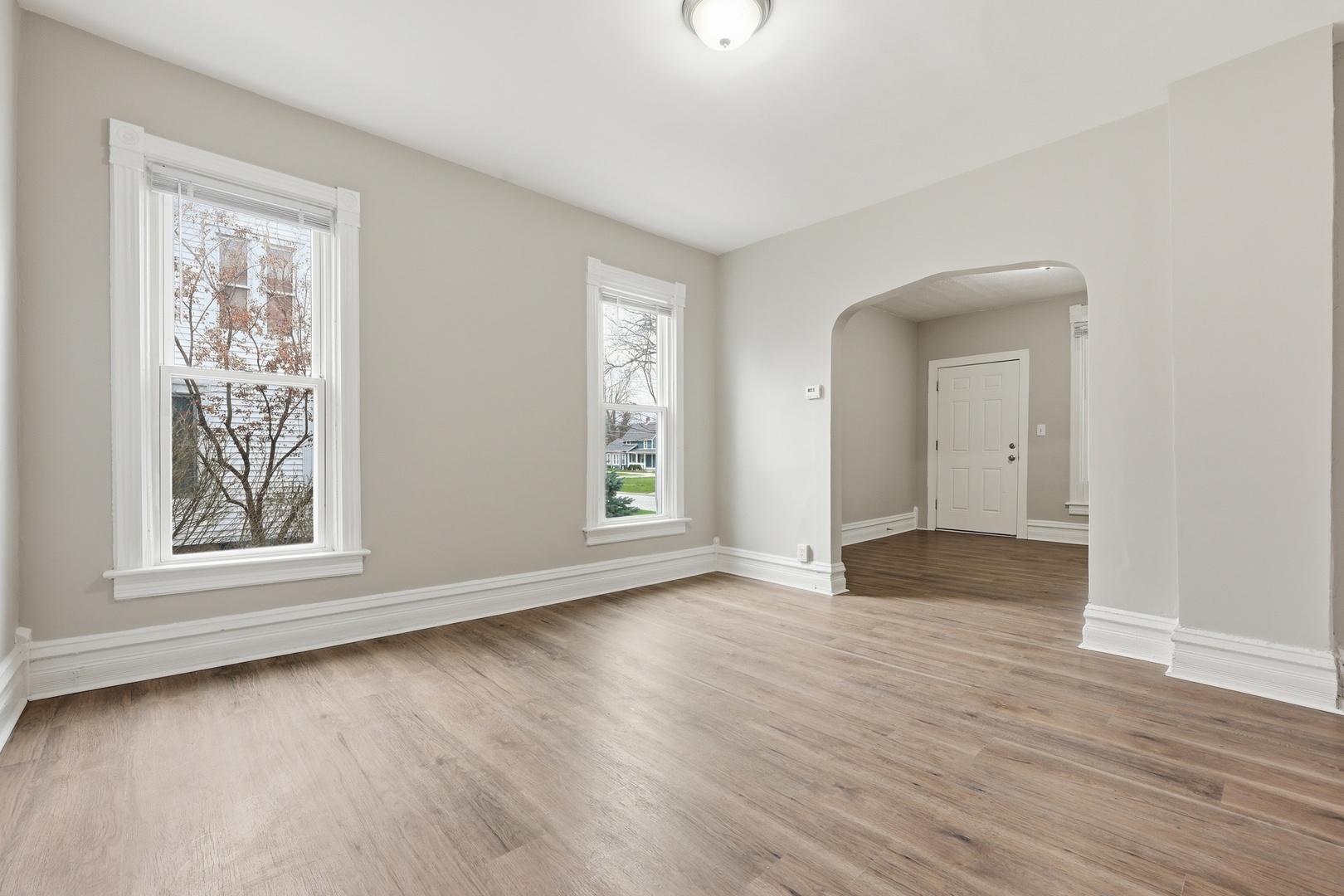 835 Oak Street Elgin, IL 60123 - Photo 7 of 41 an empty room with wooden floor and windows