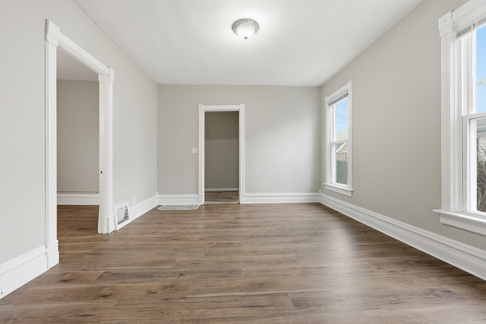 835 Oak Street Elgin, IL 60123 - Photo 8 of 41 a view of an empty room with wooden floor and a window