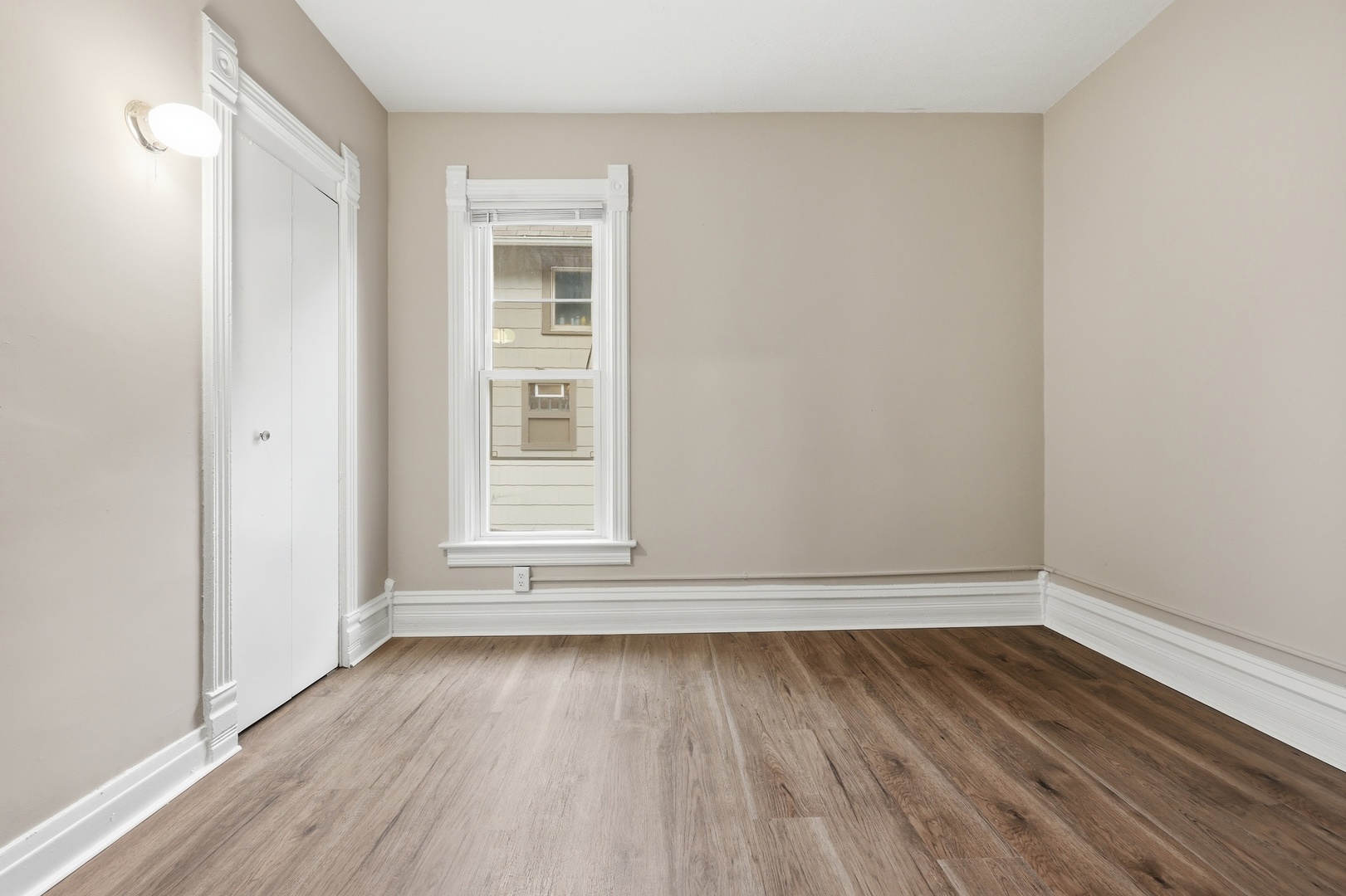 835 Oak Street Elgin, IL 60123 - Photo 9 of 41 an empty room with wooden floor and windows