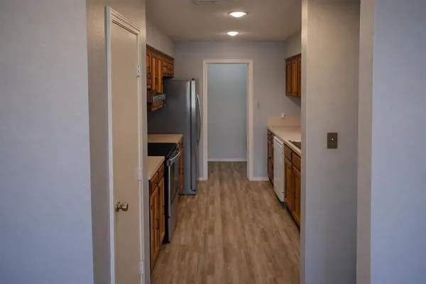a view of hallway with wooden floor