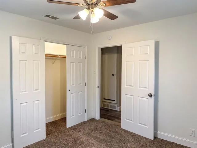 a view of a livingroom with a chandelier fan