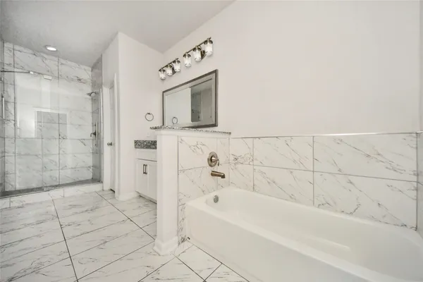 a bathroom with a bathtub and a shower