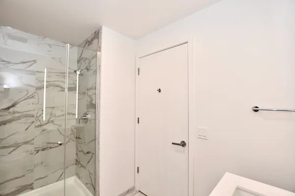 a bathroom with a shower and a glass door