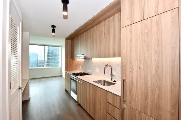 a kitchen with stainless steel appliances granite countertop a stove a sink and a refrigerator