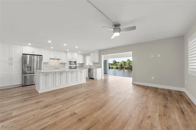 a kitchen with stainless steel appliances granite countertop a refrigerator sink and cabinets
