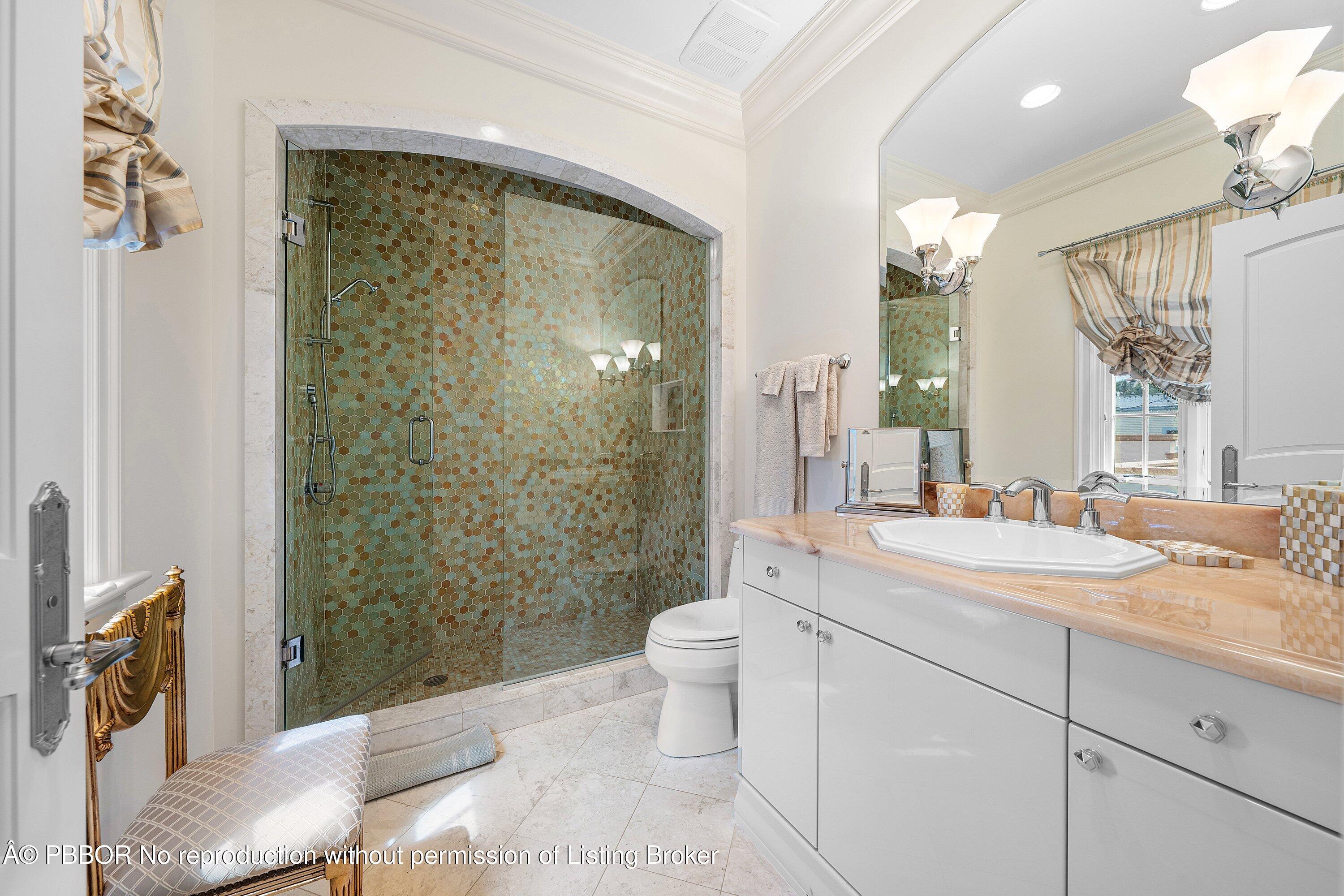242 Wells Road Palm Beach, FL 33480 - Photo 27 of 54 a bathroom with a granite countertop sink a toilet a mirror and shower