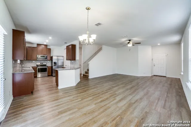 a view of a kitchen with stove and cabinets