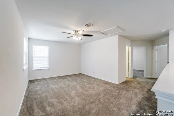 a view of an empty room with a ceiling fan