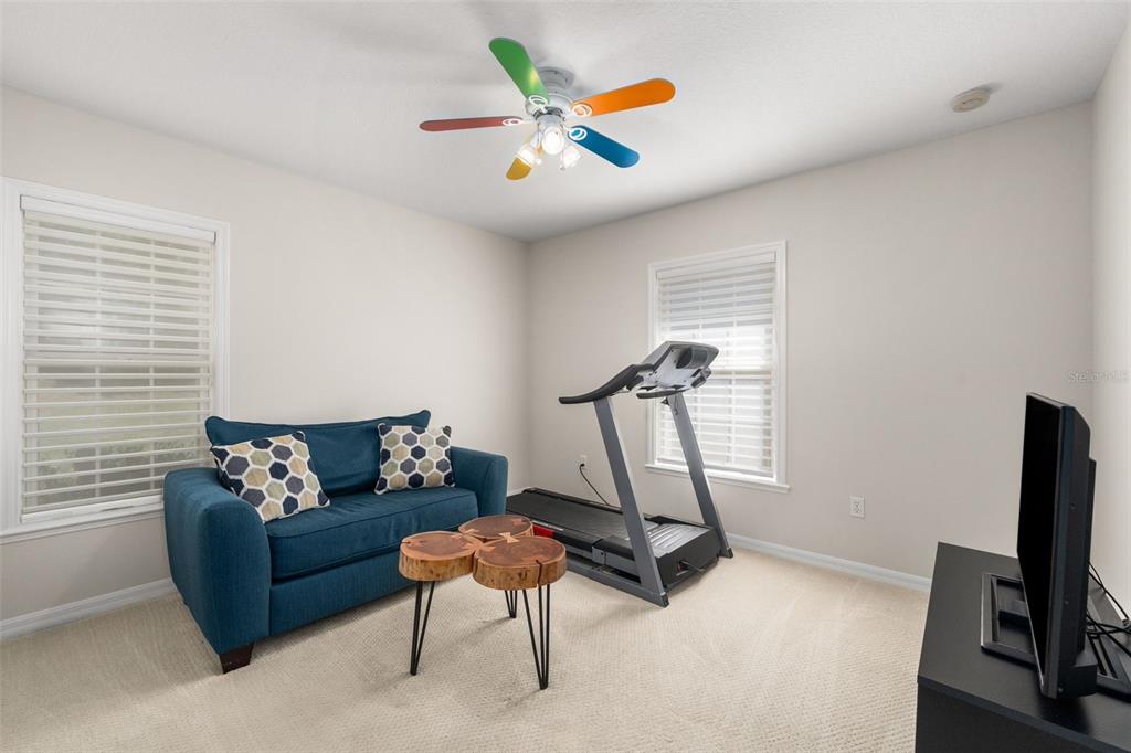 7418 White Oaks Road Alachua, FL 32615 - Photo 21 of 46 a living room with furniture and a flat screen tv