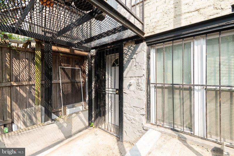 307 East 25th Street, Unit BASEMENT APARTMENT Baltimore, MD 21218 - Photo 20 of 21 a view of a house with a glass door