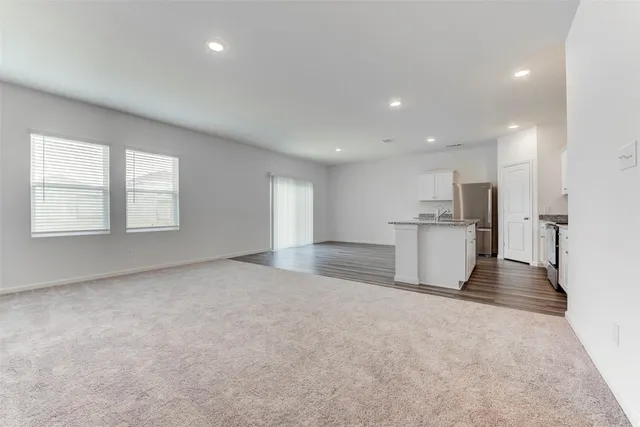 a view of a kitchen with a sink and a refrigerator