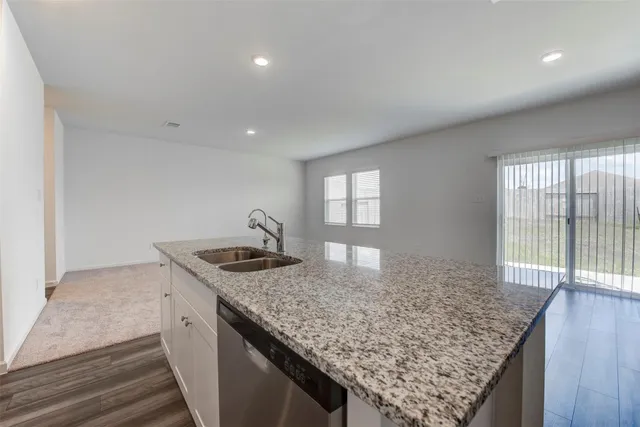 a kitchen with granite countertop kitchen island a sink stove and center island