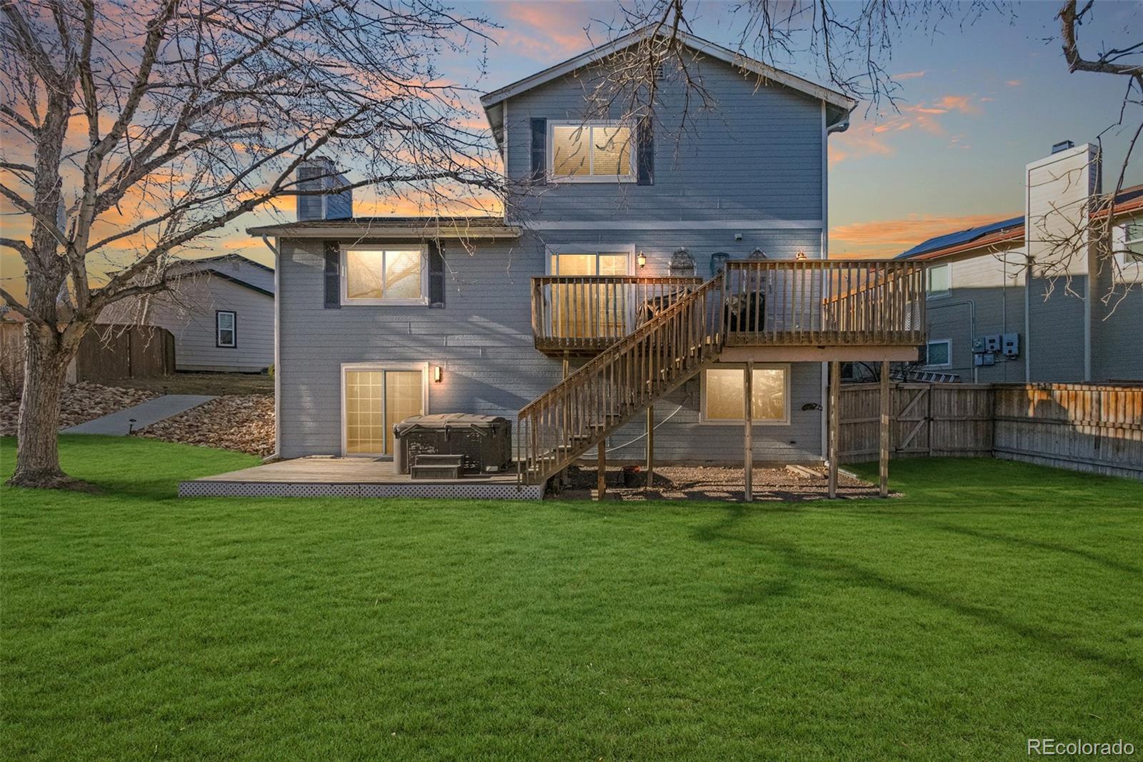 9164 Bitterweed Court Highlands Ranch, CO 80126 - Photo 20 of 27 a view of a house with a yard