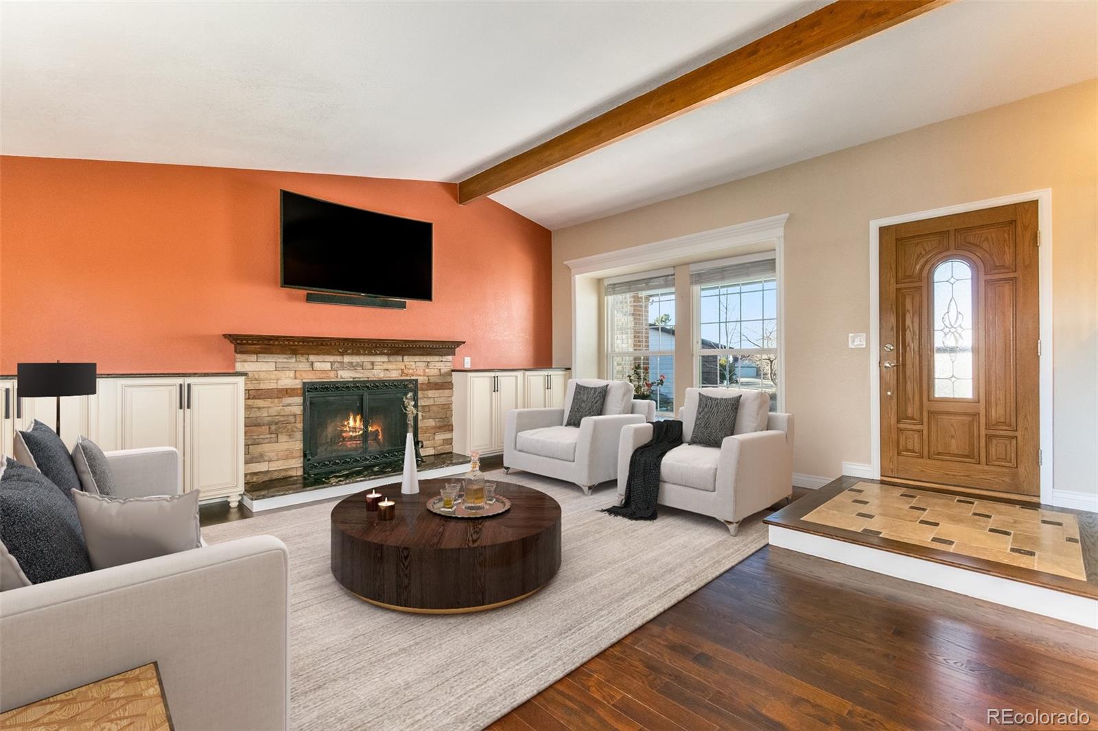 9164 Bitterweed Court Highlands Ranch, CO 80126 - Photo 4 of 27 a living room with furniture fireplace and flat screen tv