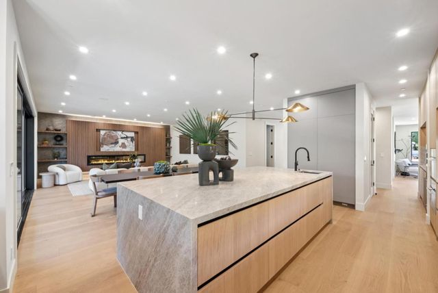 a spacious bedroom with a bed a couch and potted plant