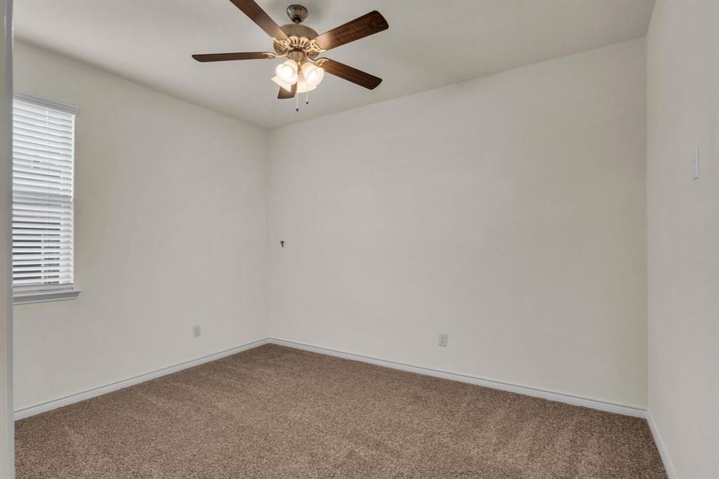 3106 Maverick Drive Forney, TX 75126 - Photo 17 of 32 an empty room with a window and a fan