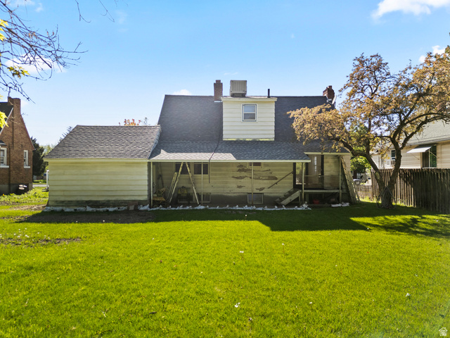 658 North 100 East Logan, UT 84321 - Photo 19 of 26 Expansive rear yard featuring a grass lawn, mature tree, and a wooden privacy fence