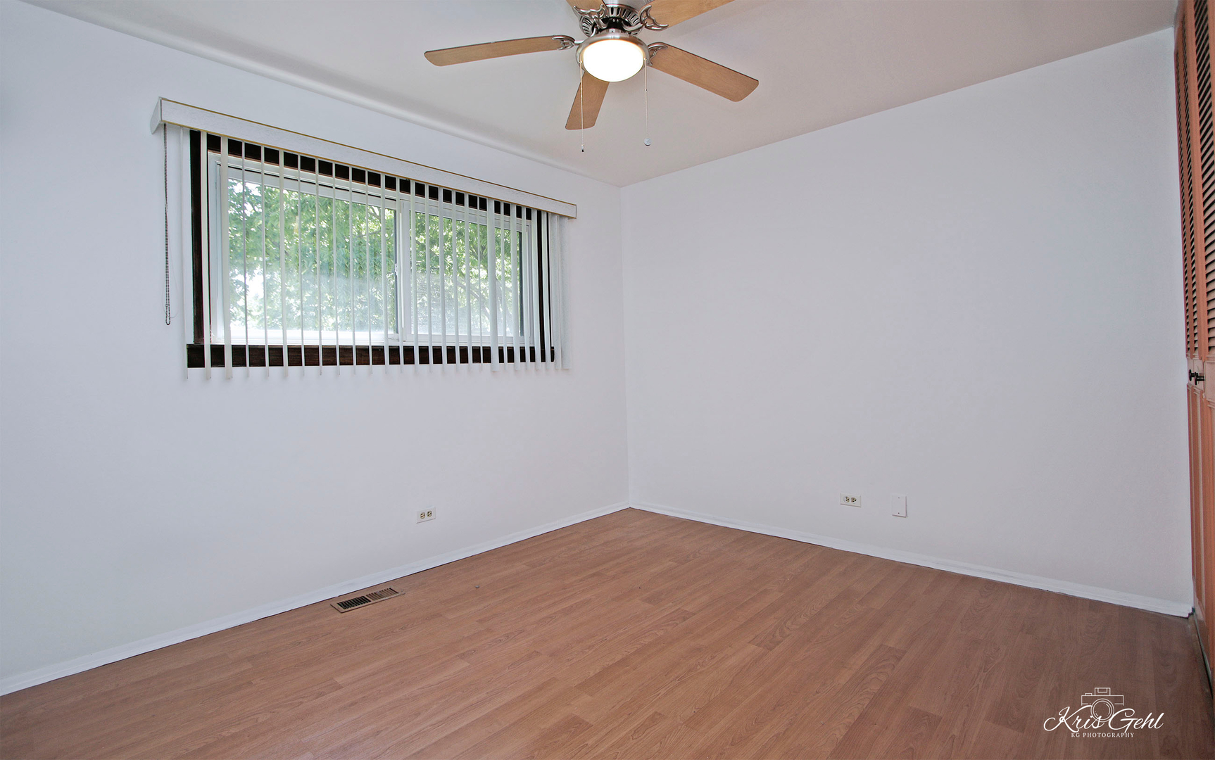 416 Arrow Trail, Unit 416 Wheeling, IL 60090 - Photo 13 of 24 an empty room with wooden floor fan and windows
