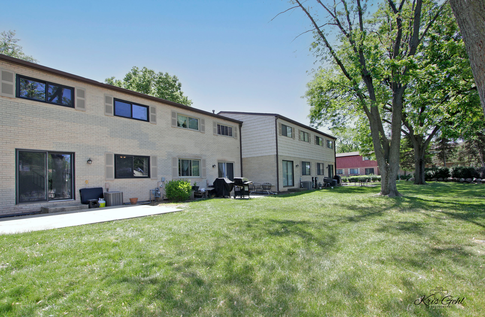 416 Arrow Trail, Unit 416 Wheeling, IL 60090 - Photo 20 of 24 a view of a house with a big yard and large trees