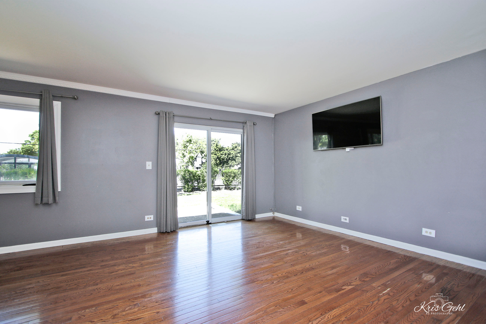 416 Arrow Trail, Unit 416 Wheeling, IL 60090 - Photo 2 of 24 a view of an empty room with wooden floor and a window