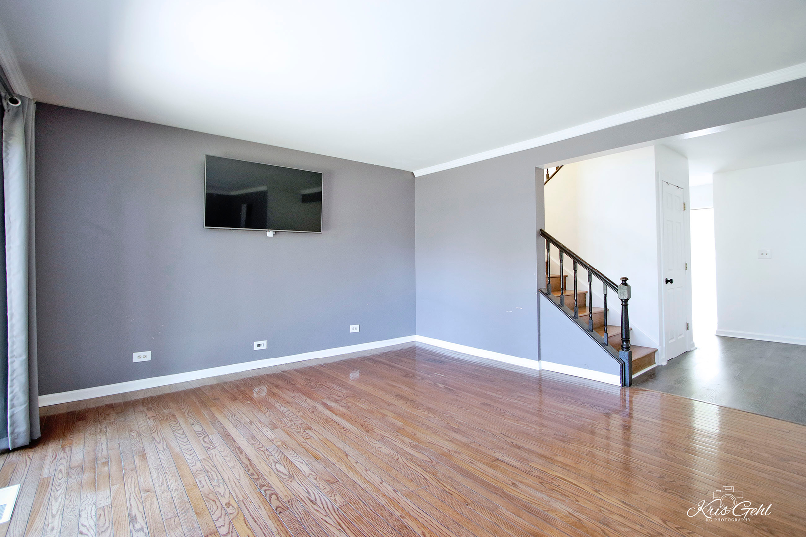 416 Arrow Trail, Unit 416 Wheeling, IL 60090 - Photo 3 of 24 a view of an empty room with wooden floor and a window