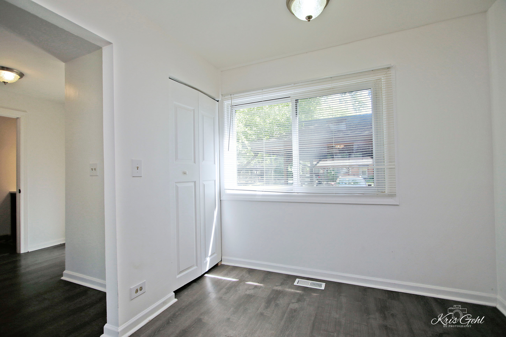 416 Arrow Trail, Unit 416 Wheeling, IL 60090 - Photo 8 of 24 an empty room with wooden floor and windows