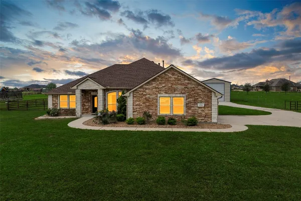 a bathroom with a tub a sink and a window