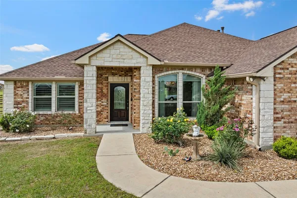 a kitchen with granite countertop a sink stove and cabinets