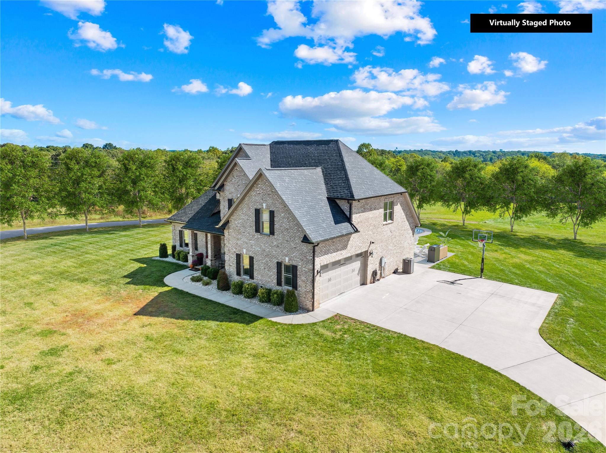 a front view of a house with porch yard outdoor seating and green space