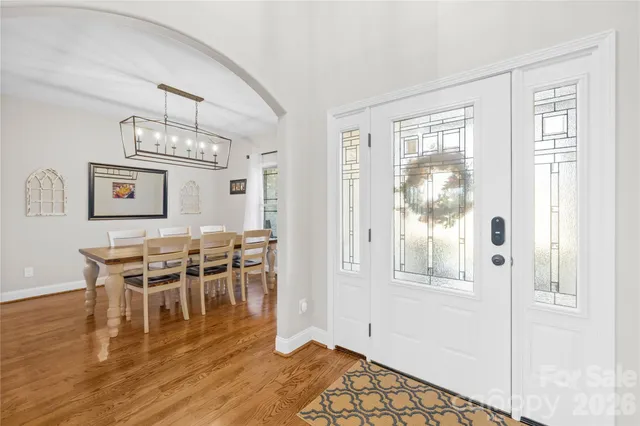 a view of a dining room with furniture wooden floor and chandelier