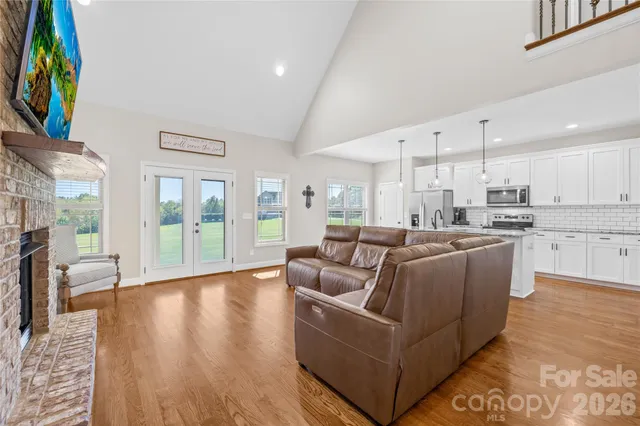 a living room with furniture and a floor to ceiling window